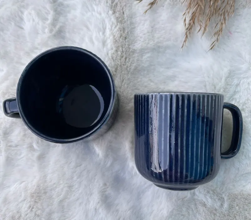 Two identical striped ceramic mugs, side by side