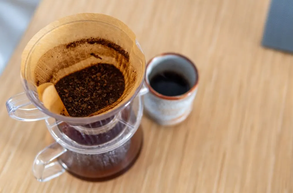 Pour-over coffee brewing into a ceramic mug - the product up close